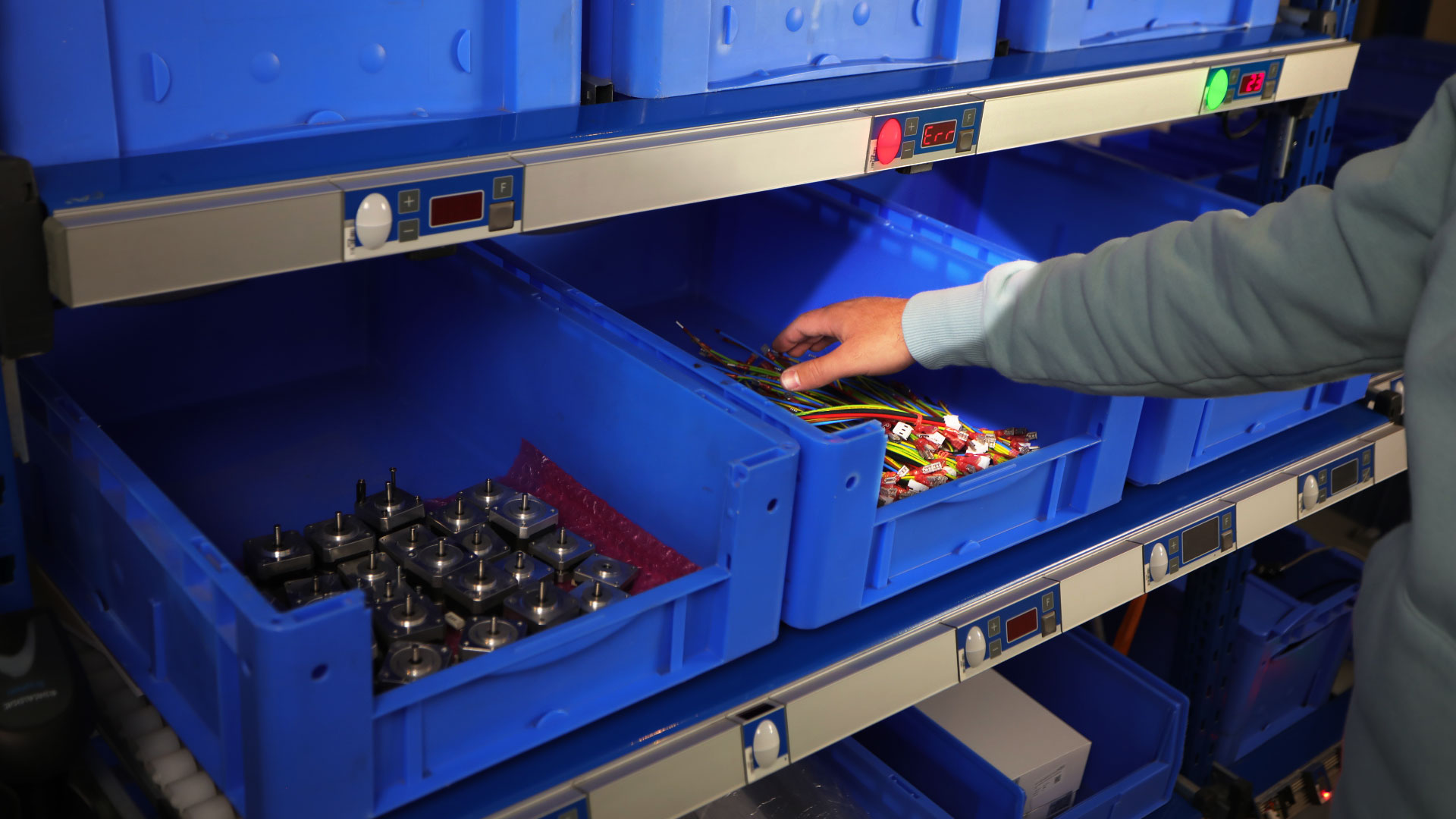 Pick-by-Light module with removal monitoring sensor detects a incorrect pick into the wrong compartment during order picking.